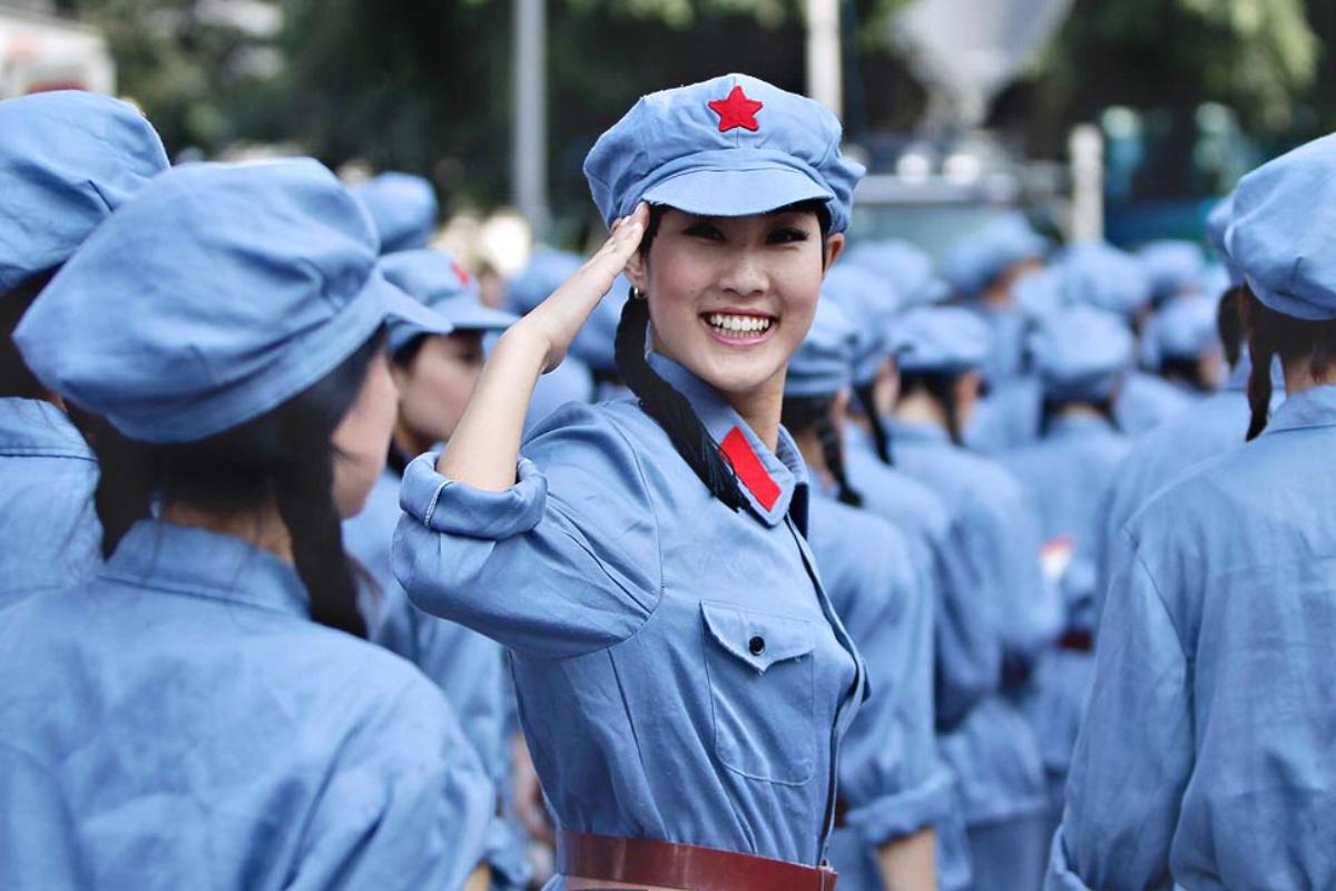 A performer dressed in Red Army uniform salutes at a revolutionary song singing event to celebrate the upcoming 90th anniversary of the founding of the Communist Party of China (CPC), in Chongqing municipality